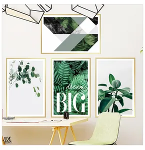 Detail of four-piece tropical plant wall art set with golden frames in a Nordic bedroom setup