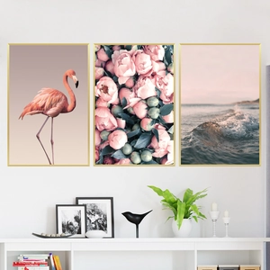 Three-piece flamingo and peony wall art set with minimalist gold frames in a modern interior