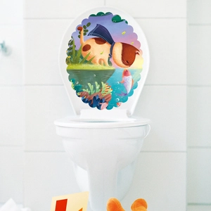 Waterproof cartoon cat and fish wall sticker applied on a white bathroom toilet lid