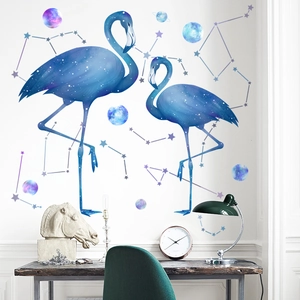 Starry sky flamingo wall sticker set with colorful planets on a white bedroom wall