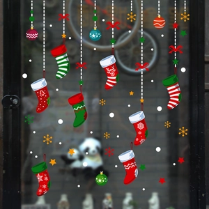 Christmas window stickers with festive socks, snow and ornaments on a glass surface