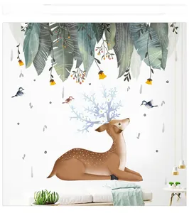 Nordic wall sticker featuring a brown deer with tropical leaves and small floral accents