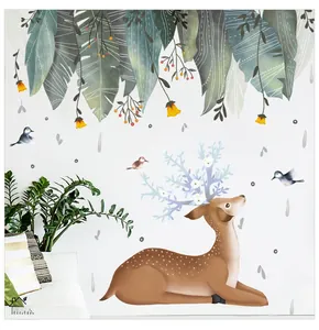 Detail of Nordic wall sticker featuring a deer and green leaves in a cozy living room