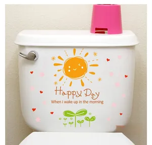Cartoon sun and flower stickers with Happy Day text applied to a white toilet tank