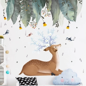 Nordic forest wall decal featuring a deer with flowers, green leaves and birds on a white wall