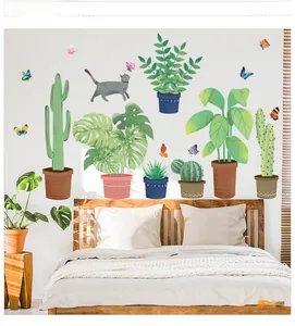 Detail of tropical plant and cat wall decals applied in a minimalist bedroom setting