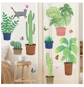 Close-up of tropical plant wall decals featuring a grey cat and green monstera leaves