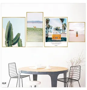 Detail of 5-piece modern wall art set with golden frames featuring cactus and beach motifs