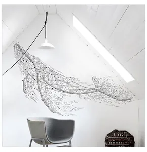 Minimalist geometric black whale wall sticker detail in a modern attic bedroom setting