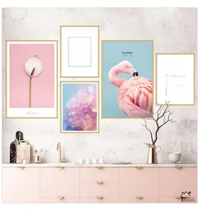 Modern wall art set with pink flamingos and calla lilies above a pink cabinet