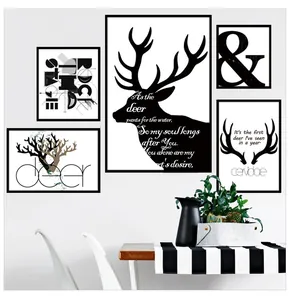 Close-up of minimalist black and white wall art set featuring deer silhouette and geometry