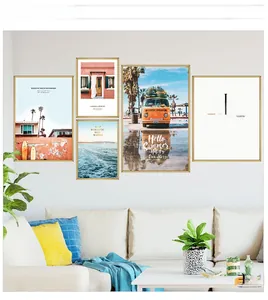 Detailed view of 5-piece beach landscape wall art with minimalist gold frames on a living room wall