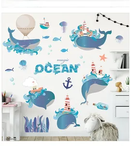 Detail of blue whale wall decals with lighthouse and jellyfish for nursery wall decor