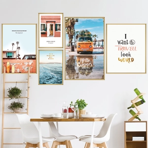 Modern 5-piece beach landscape wall art set with slim gold frames in a dining room