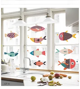 Detail view of colorful cartoon sailfish wall decals applied to a bright kitchen window