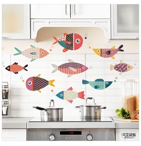 Detail of nine colorful cartoon fish wall stickers on a clean kitchen tile background