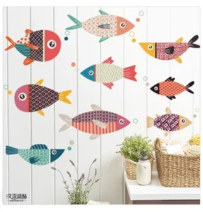 Detail of waterproof cartoon fish wall stickers with geometric patterns on a wooden wall