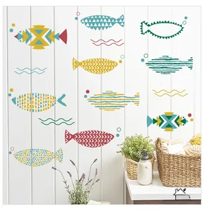 Detail of Nordic fish wall stickers with abstract patterns on white wooden bathroom tiles