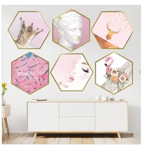 Set of six hexagonal Nordic pink flamingo and gold frame wall art on a white cabinet