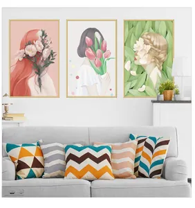 Three-piece floral wall art and geometric pattern cushions in a cozy home setting