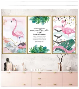 Detail of Nordic flamingo wall decals and tropical leaf art with gold frames on white wall