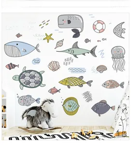 Detail of marine design set stickers with whales and turtles on a white nursery wall