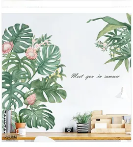 Hand-painted Monstera wall stickers with green leaves and pink flowers on white wall