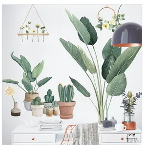 Détail de stickers muraux plantes vertes avec cactus et fleurs suspendues sur un bureau