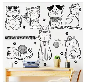Detail of cartoon cat wall stickers showing various playful kitten designs on white wall