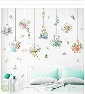 Detail of watercolor succulent plant wall stickers with black geometric frames and birds