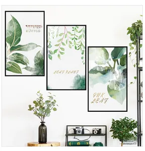 Detailed view of three watercolor tropical plant wall decals with minimalist black frames