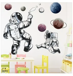 Detail of self-adhesive astronaut and planet wall stickers in a bright children room setup