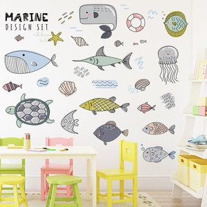 Nursery wall decals featuring cartoon whales and sea animals in a marine design set