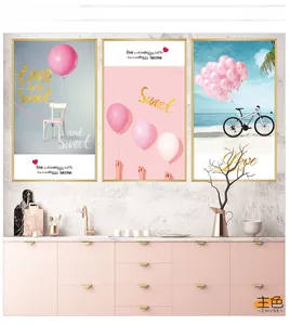 Detailed view of pink balloon and bicycle wall art triptych in modern gold frames