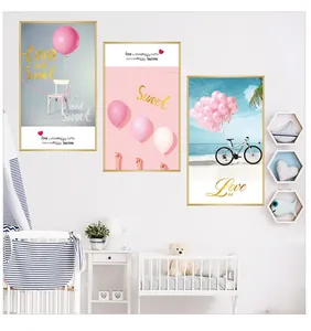 Detail of three-piece triptych wall art with pink balloons, bicycle and gold frames