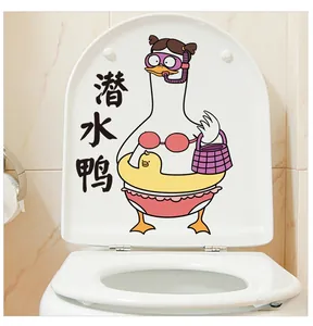 Detail of waterproof cartoon diving duck sticker applied to a white toilet lid surface