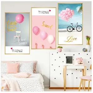 Detail of pink balloon and bicycle beach art prints with gold frames in modern bedroom