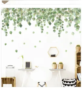 Detail of green leaf wall sticker with inspirational quote on white minimalist wall
