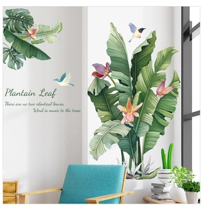 Detail of tropical plantain leaf wall stickers with pink flowers and birds in living room