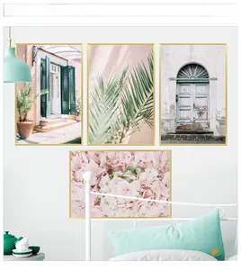 Set of four pastel wall art pieces with gold frames featuring architecture and plants