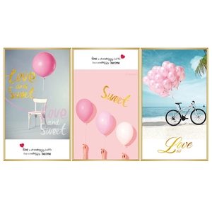 Three-piece Nordic wall art set featuring pink beach scenes and bicycle with gold frames