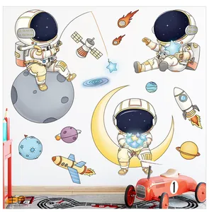 Detailed view of astronaut wall stickers with rocket and stars on a white nursery wall