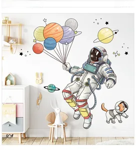 Nursery wall decals featuring cartoon astronaut and planets in a bright kids room