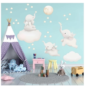 Nursery room setup featuring cute flying elephant wall stickers with clouds and stars