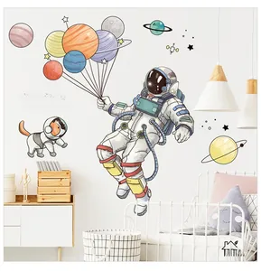 Detail of cartoon astronaut wall stickers with planets in a cozy kid's room setting