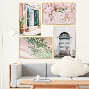 Modern set of 4 landscape wall art prints with gold frames over a grey sofa decor
