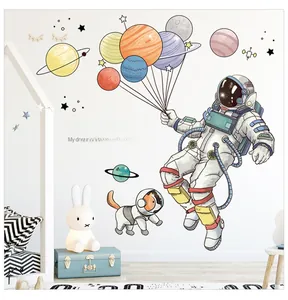 Close-up of outer space wall stickers with cartoon astronaut and colorful planets for kids