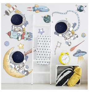 Detailed view of astronaut and spaceship wall decals in a child's bedroom setting