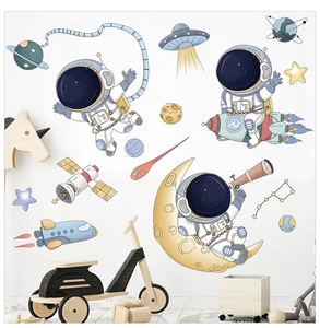 Nursery room wall with cartoon astronaut stickers and colorful space planets set
