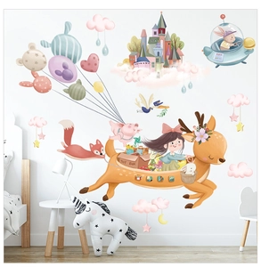 Detail of cartoon wall stickers with girl on deer, balloons, and animals in a kid room